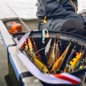 fishing bait lures in bucket on boat