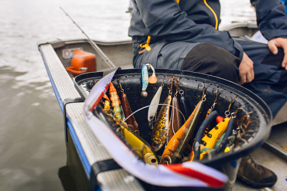 fishing bait lures in bucket on boat